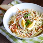 Light coleslaw salad with hard boiled egg, scallions and apples