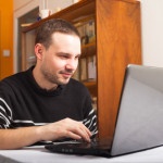 Smiling man with laptop